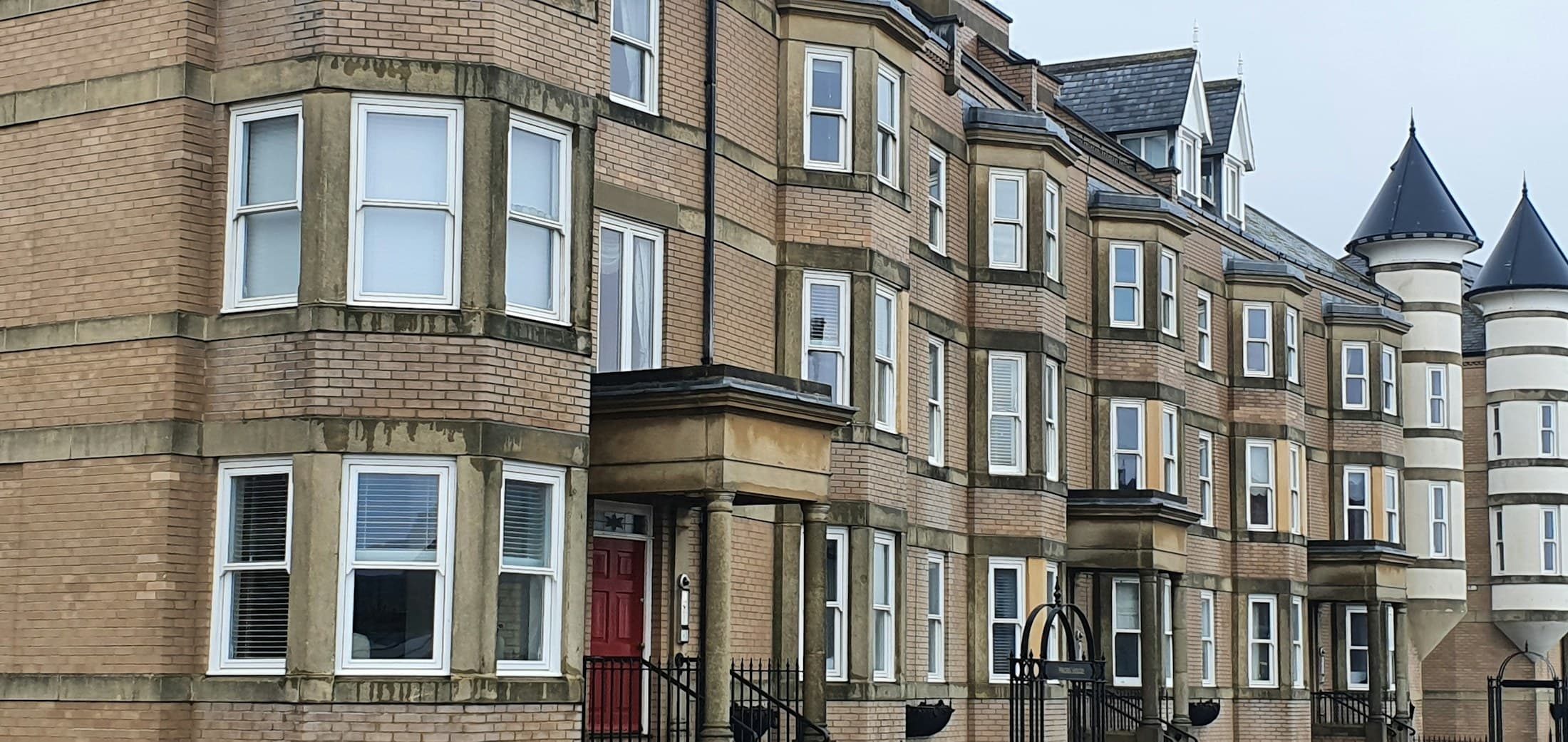 Row of red-brick terraced houses before modernisation